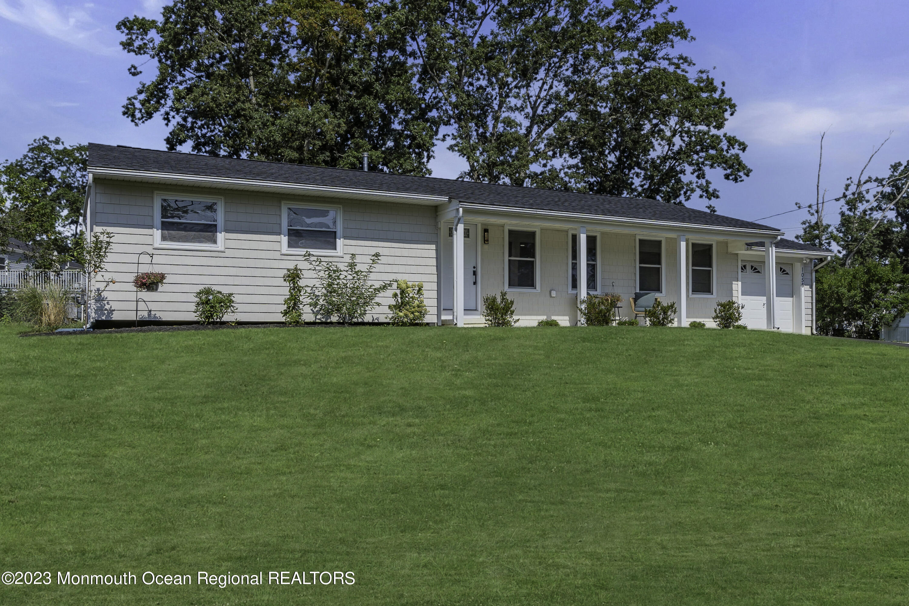 a front view of house with yard and green space