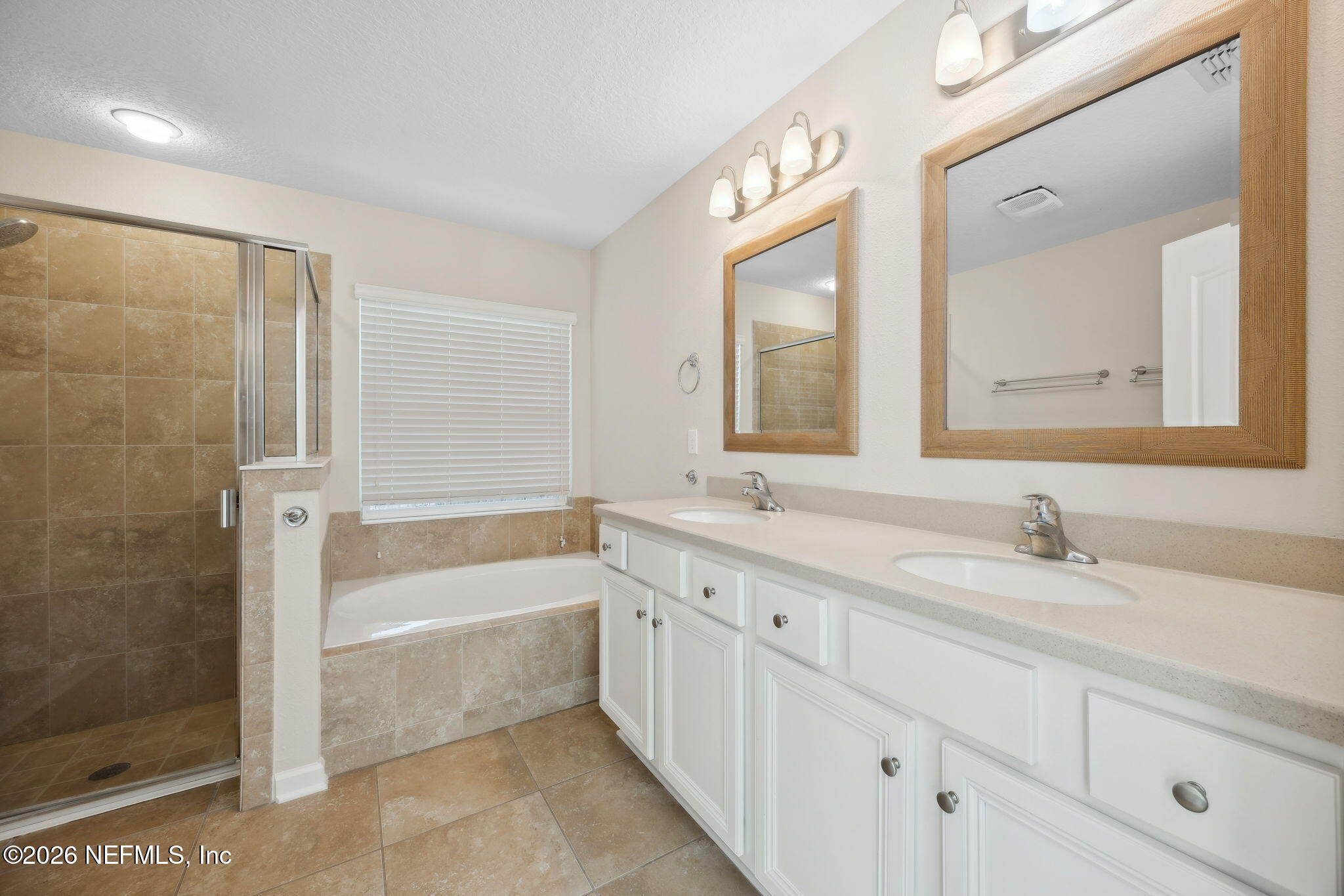 1602 Indigo Street Fernandina Beach, FL 32034 - Photo 22 of 35 a bathroom with a double vanity sink mirror double and a bathtub