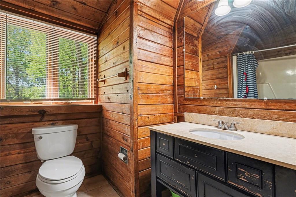 2530 Rockbridge Road Northwest Conyers, GA 30012 - Photo 15 of 45 a bathroom with a sink a toilet a mirror and shower