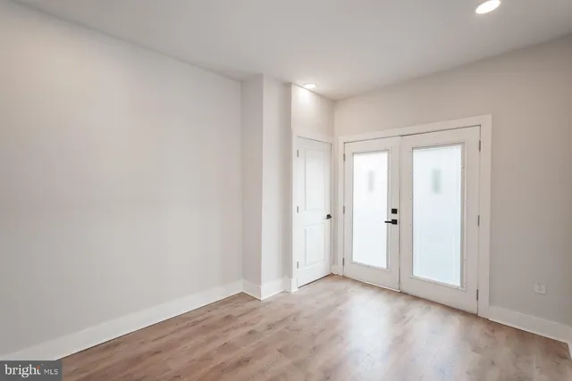 a view of an empty room and wooden floor