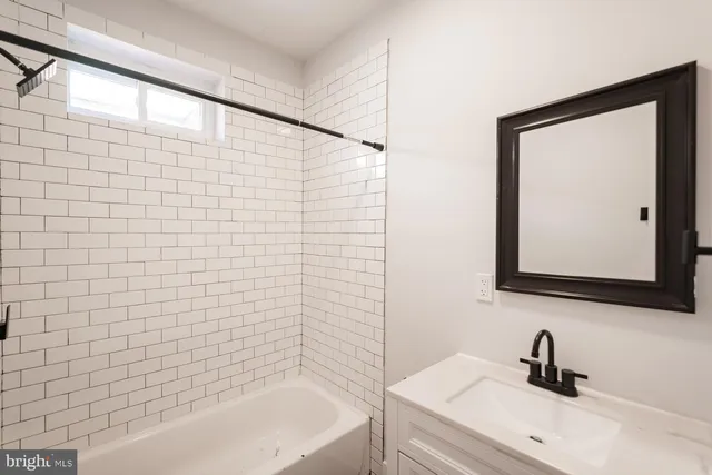a bathroom with a sink a mirror and a bathtub