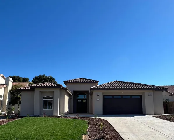 a kitchen with stainless steel appliances a stove top oven a refrigerator a sink and dishwasher