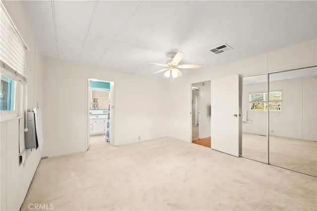 a view of washer and dryer with bathroom in the background