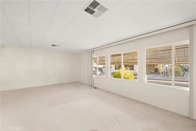 a view of a livingroom with wooden floor and a ceiling fan