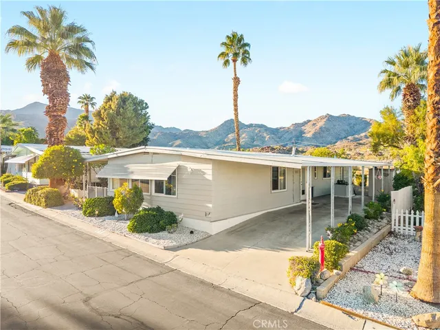 a very nice looking room with a large window and a wooden floor