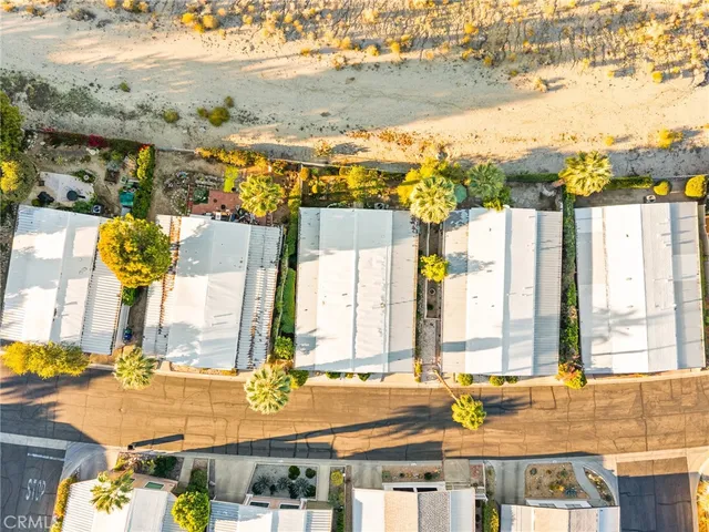 a view of a swimming pool with a lawn chairs and a yard
