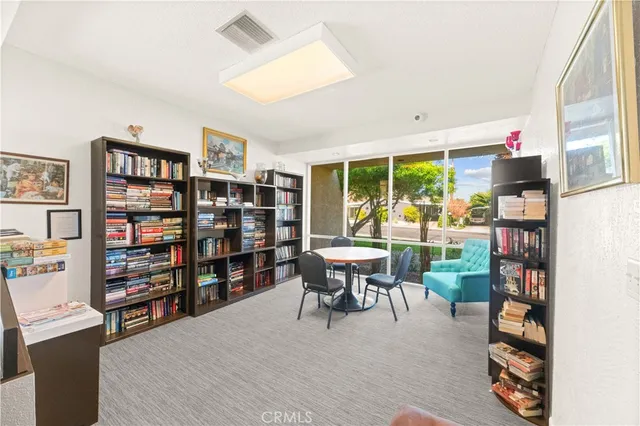 a view of a swimming pool with a lawn chairs and a fire pit