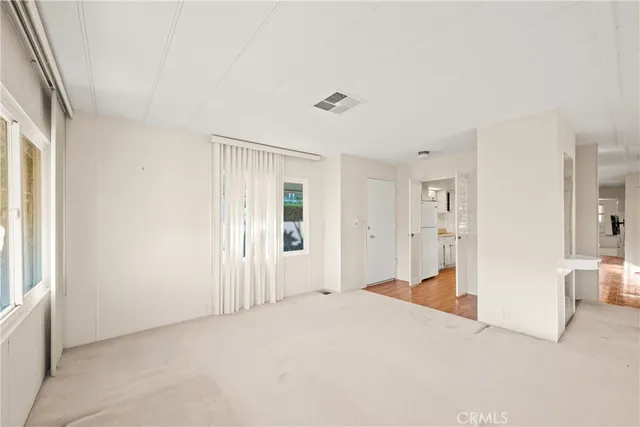 a large white tub sitting in a room next to a window