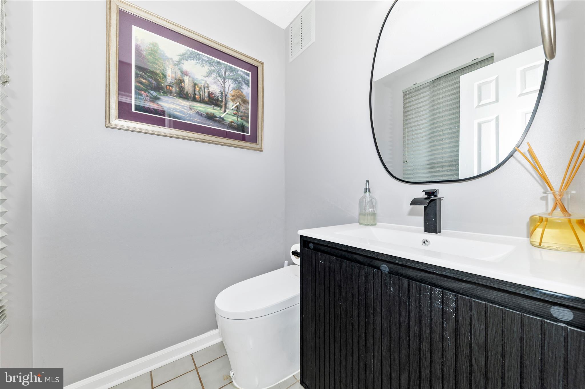 19010 Wootton Avenue Poolesville, MD 20837 - Photo 15 of 51 a bathroom with a sink and a mirror
