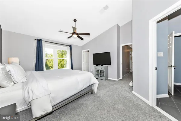 a bedroom with a bed and a large window