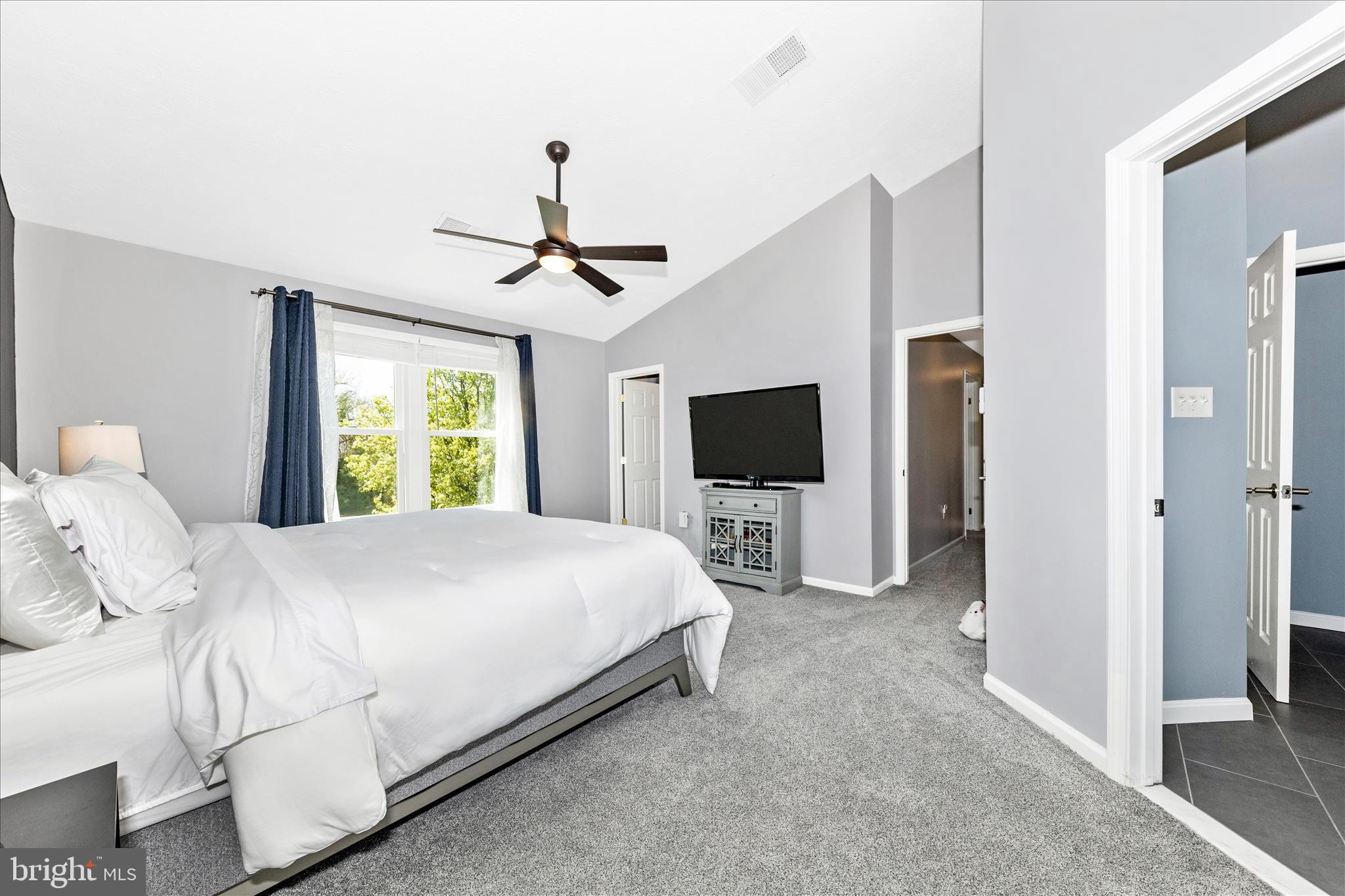 19010 Wootton Avenue Poolesville, MD 20837 - Photo 19 of 51 a bedroom with a bed and a flat screen tv