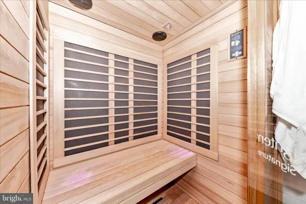 a view of walk in closet with clothes