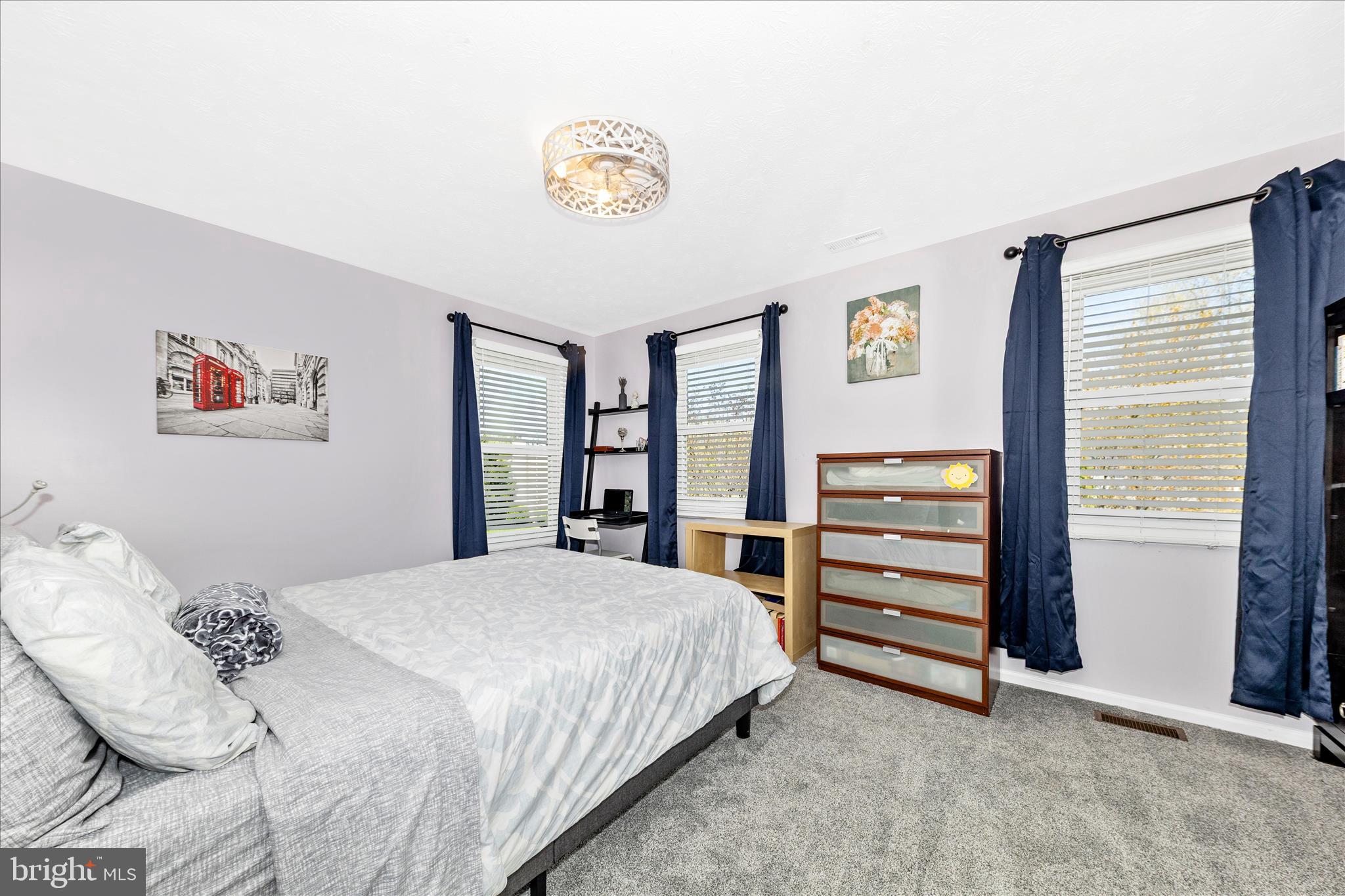 19010 Wootton Avenue Poolesville, MD 20837 - Photo 24 of 51 a bedroom with a bed and a chandelier