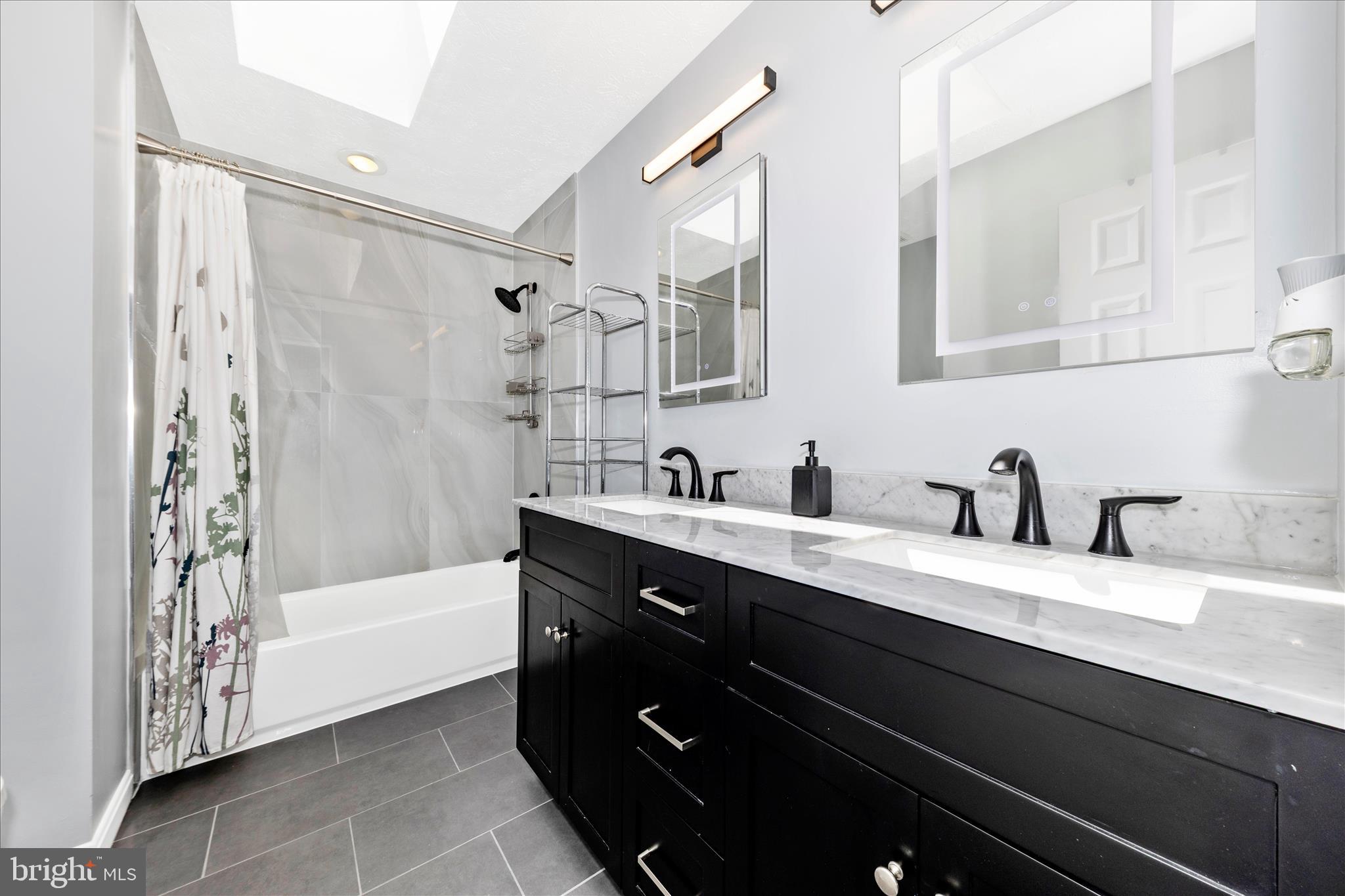 19010 Wootton Avenue Poolesville, MD 20837 - Photo 28 of 51 a bathroom with a tub sink and mirror