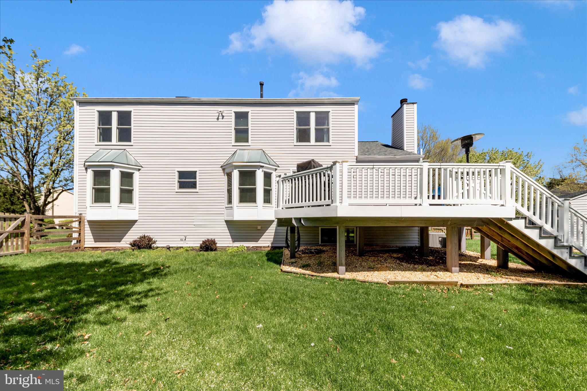 19010 Wootton Avenue Poolesville, MD 20837 - Photo 38 of 51 a view of a house with a deck and a yard