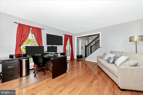 a living room with furniture rug and a window