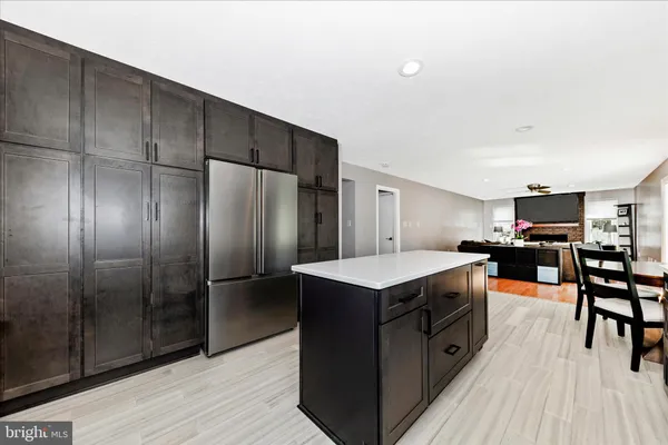 a kitchen with kitchen island a counter top space and stainless steel appliances