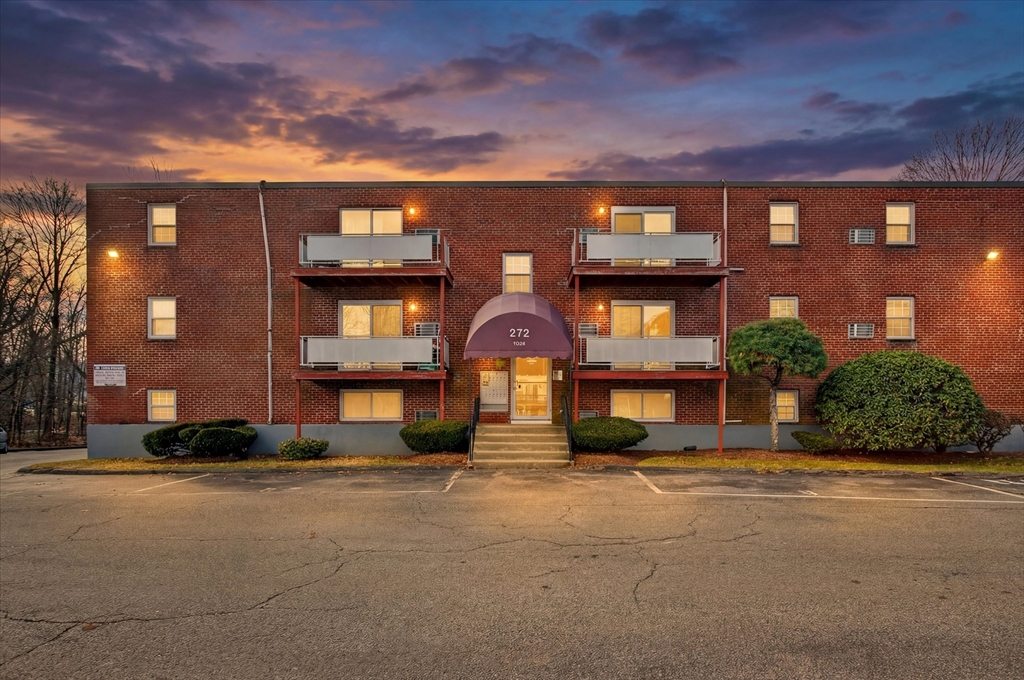 a front view of a building with a yard