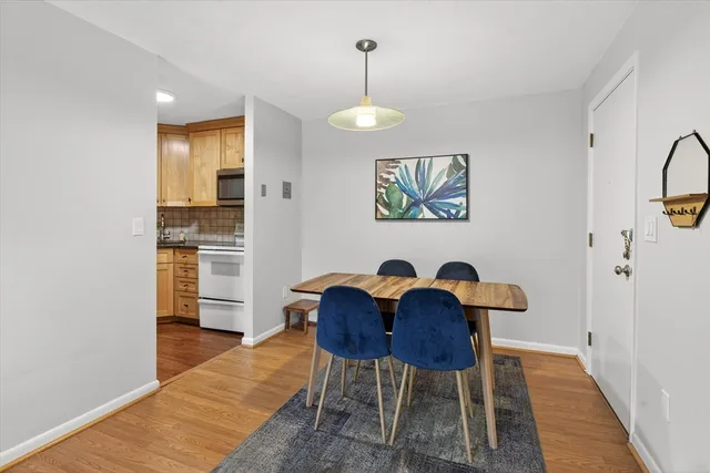 a view of a dining room with furniture and wooden floor