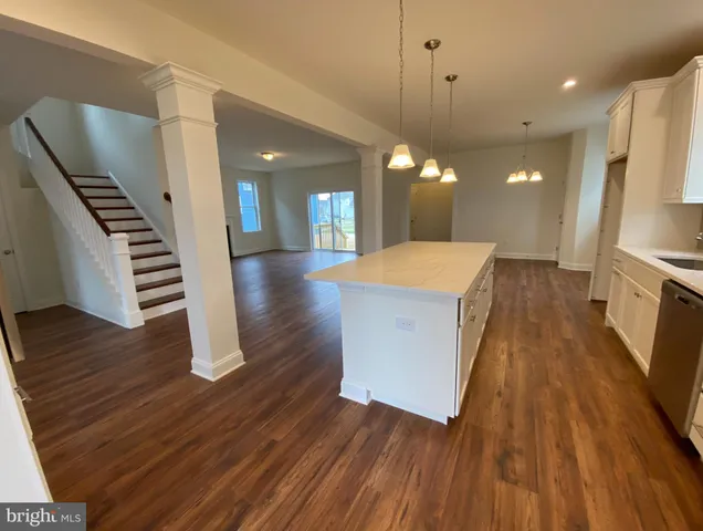 a view of a room with wooden floor and chandelier