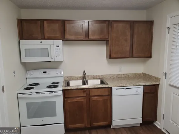 a kitchen with cabinets appliances and a sink