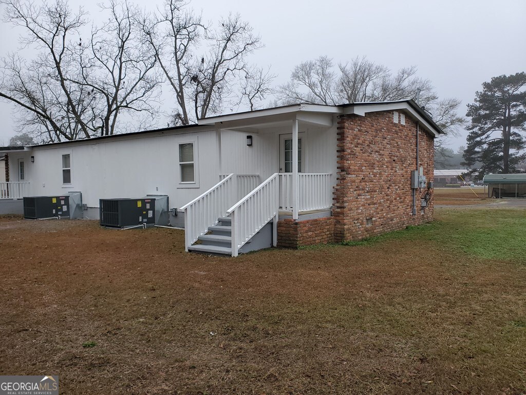 203 Enterprise Street, Unit A Dublin, GA 31021 - Photo 4 of 4 a view of a house with a back yard