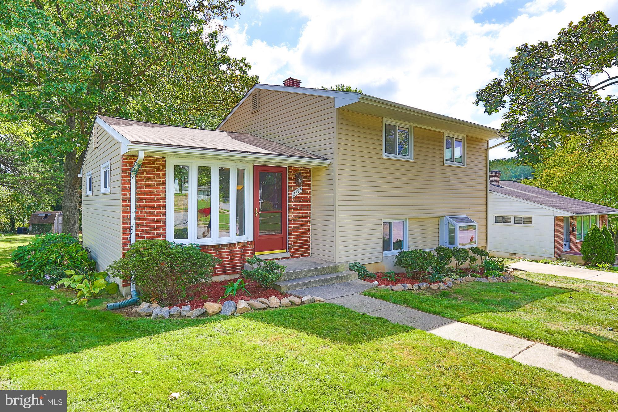 5625 Huntsmoor Road Baltimore, MD 21227 - Photo 1 of 30 a front view of house with yard and green space