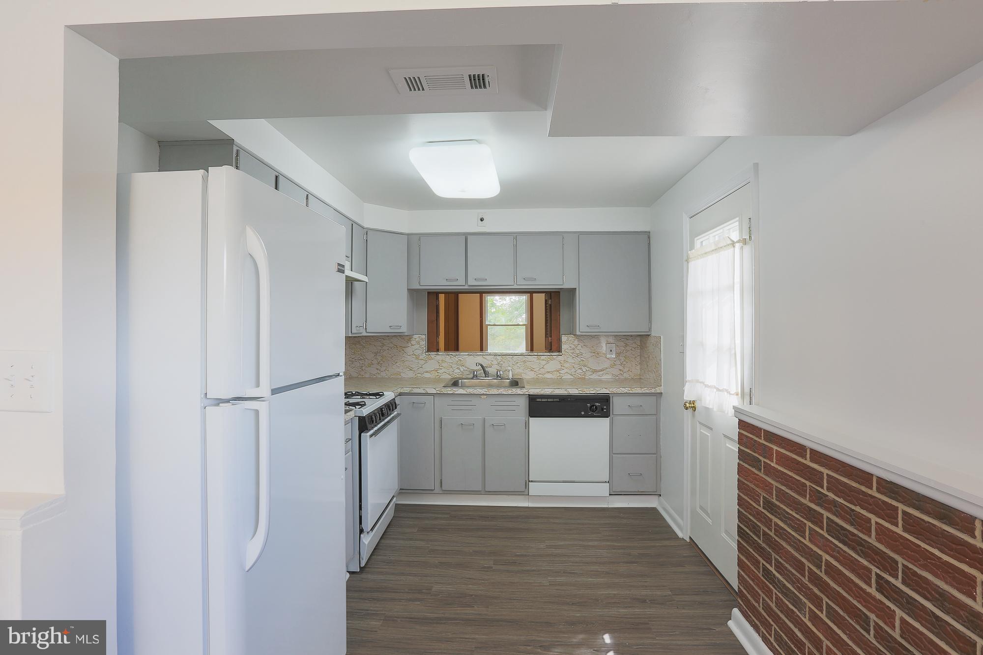 5625 Huntsmoor Road Baltimore, MD 21227 - Photo 12 of 30 a kitchen with stainless steel appliances granite countertop a refrigerator and a sink