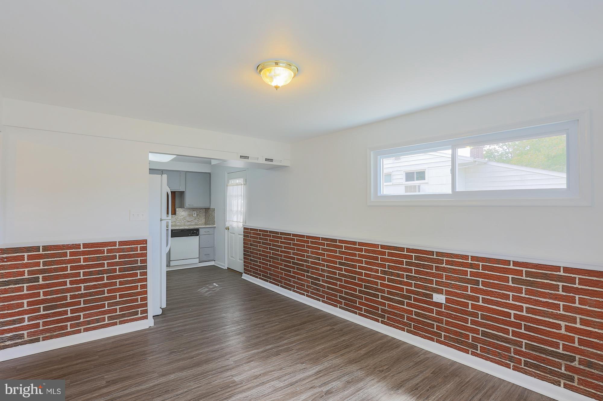 5625 Huntsmoor Road Baltimore, MD 21227 - Photo 13 of 30 a view of empty room with wooden floor