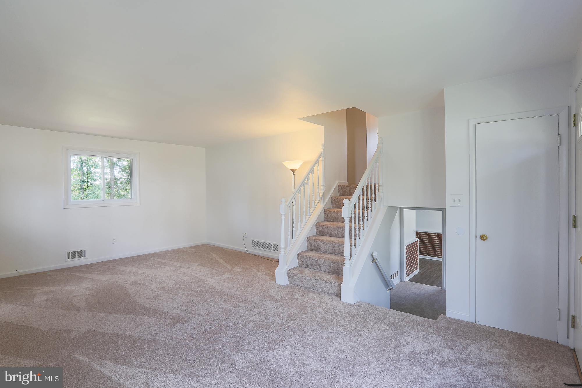 5625 Huntsmoor Road Baltimore, MD 21227 - Photo 4 of 30 a view of an empty room with stairs