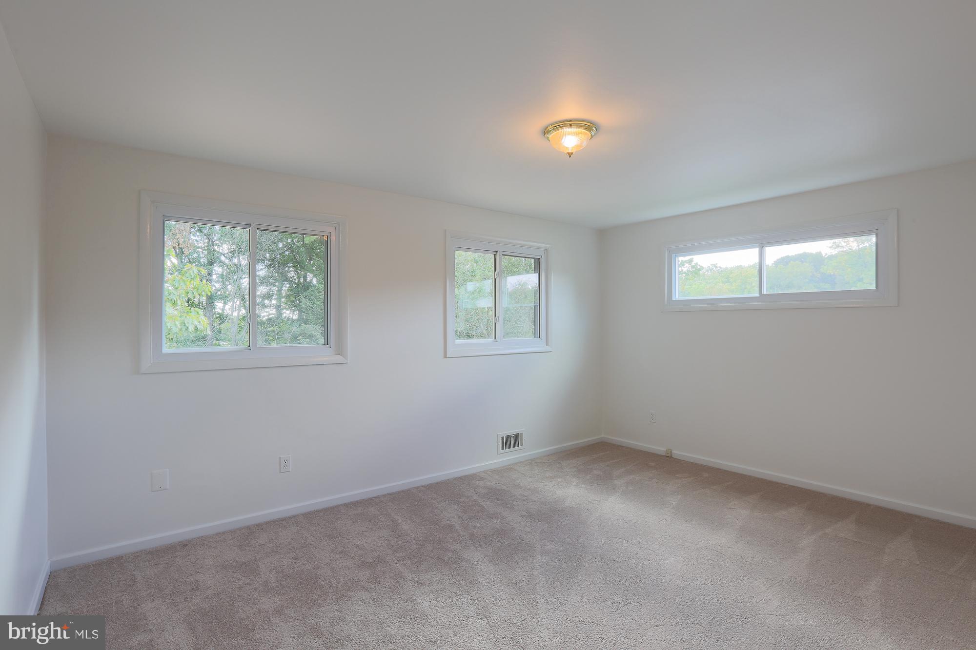 5625 Huntsmoor Road Baltimore, MD 21227 - Photo 6 of 30 an empty room with windows