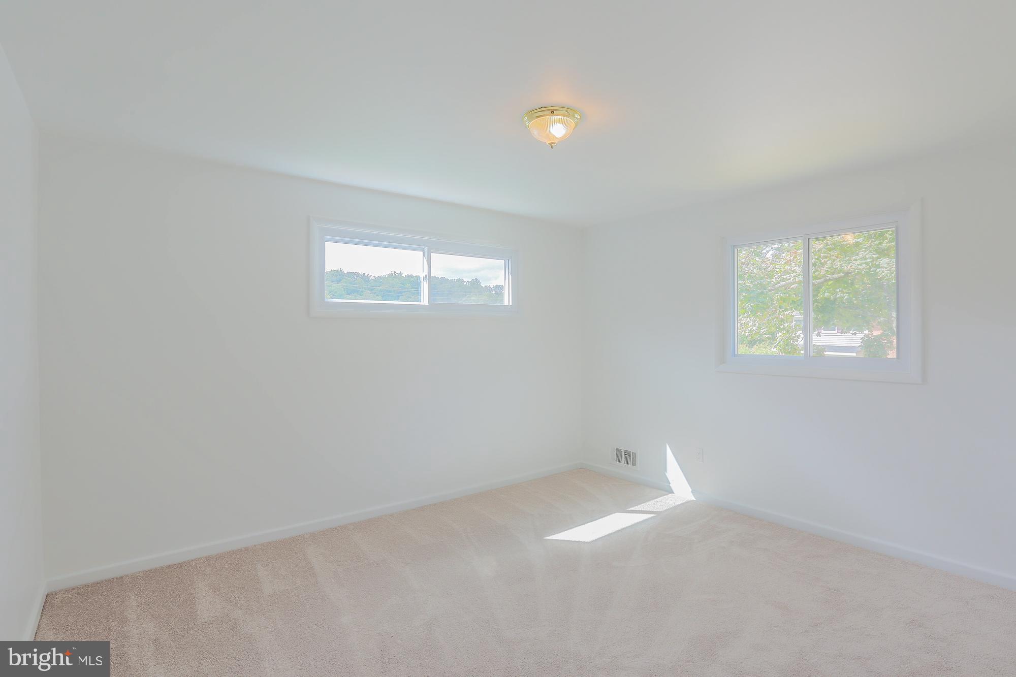 5625 Huntsmoor Road Baltimore, MD 21227 - Photo 7 of 30 an empty room with windows