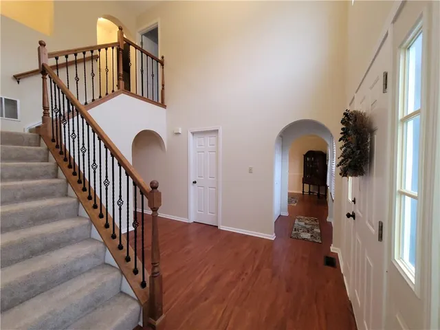 a view of entryway with wooden floor and stairs