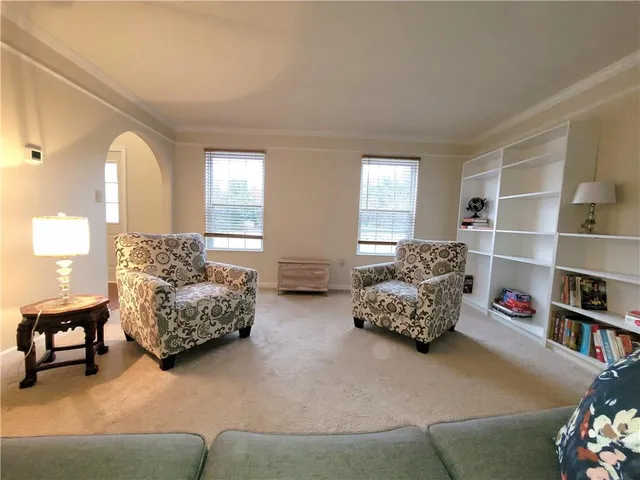 a bedroom with furniture and a large window