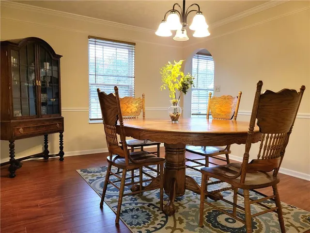 a view of a dining room with furniture and chandelier