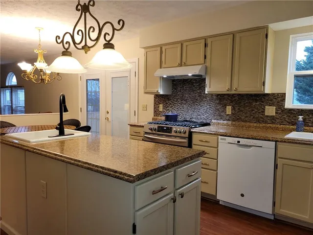 a kitchen with a sink cabinets and window