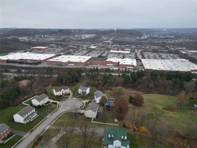 an aerial view of a house with yard