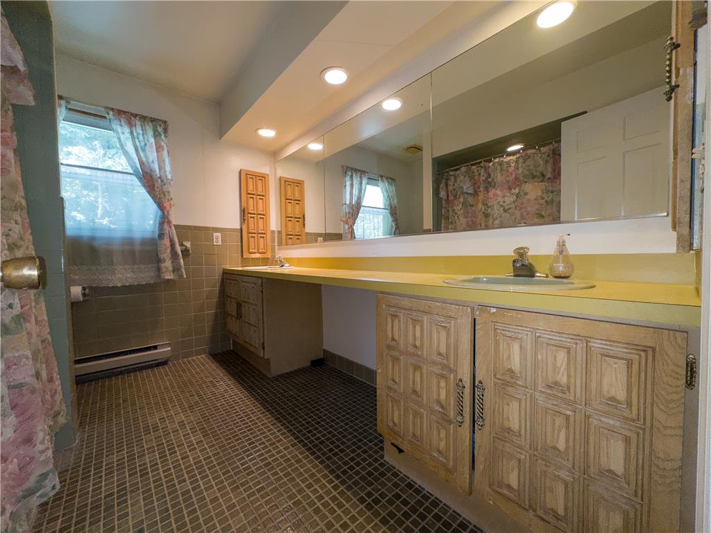 2516 Rachael Lane Orefield, PA 18069 - Photo 24 of 45 A classic bathroom features a long vanity with dual sinks, overhead mirror, and integrated lighting.