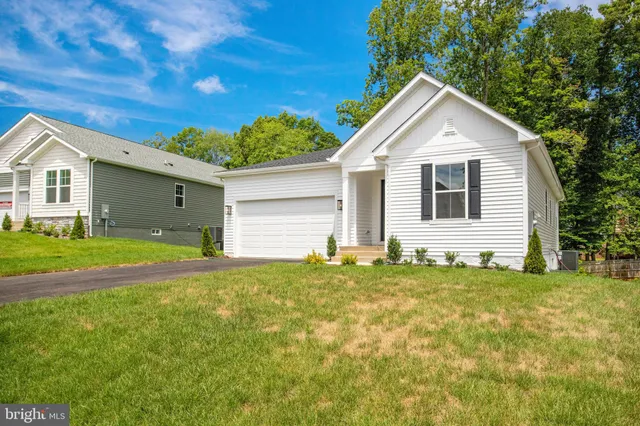 a view of backyard of house with green space