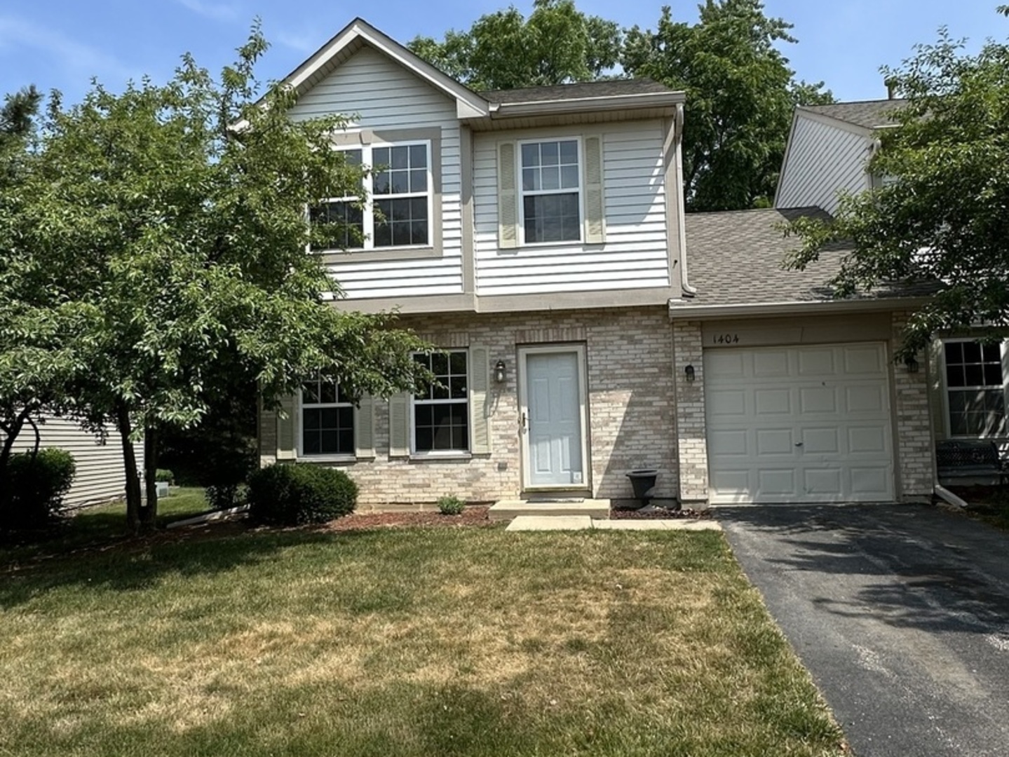 1404 West Split Oak Circle Round Lake Beach, IL 60073 - Photo 1 of 1 a front view of a house with a yard