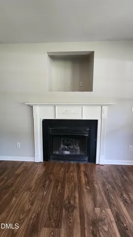 a view of empty room with a fireplace