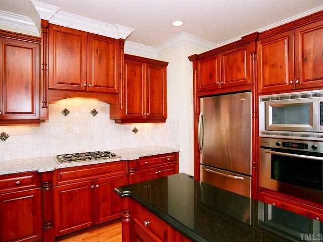 1629 Stannard Trail Raleigh, NC 27612 - Photo 6 of 12 a kitchen with stainless steel appliances granite countertop a refrigerator a stove top oven and cabinets