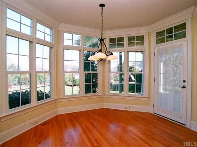 1629 Stannard Trail Raleigh, NC 27612 - Photo 7 of 12 a view of an empty room with a window and wooden floor