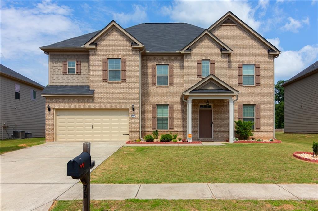 a front view of a house with a yard