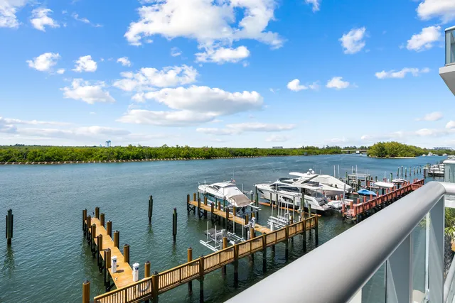 a view of a lake with lawn chairs