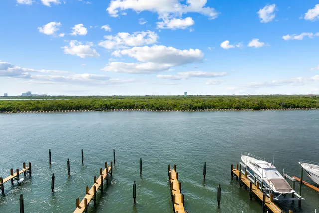 a view of a balcony with chairs and wooden floor