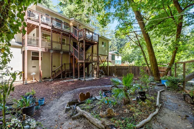 a view of a house with a yard and potted plants