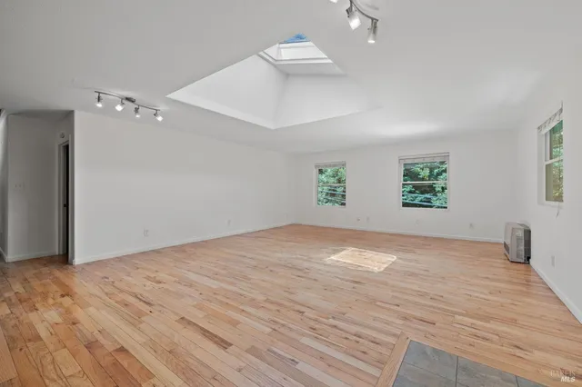 an empty room with windows and entrance