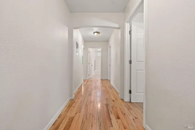 a view of a hallway with wooden floor