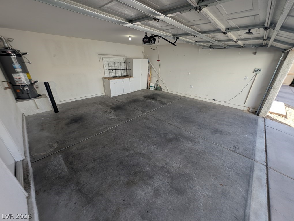 9121 Spoonbill Ridge Place Las Vegas, NV 89143 - Photo 25 of 26 A spacious, clean garage ready for vehicles or extra storage.